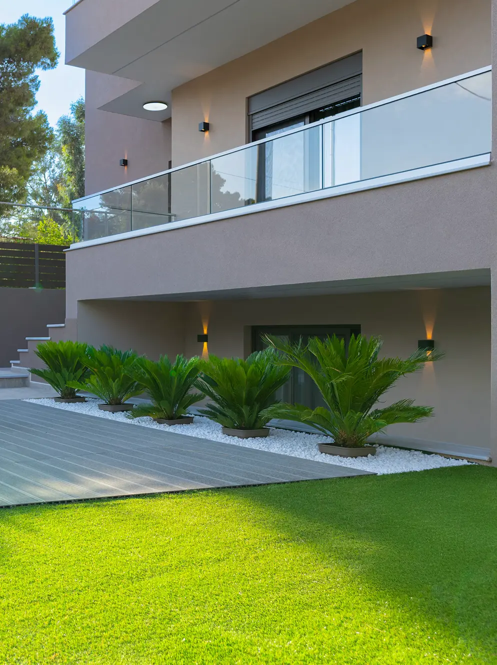 Davi Apartments exterior with glass balconies and warm lighting in Artemida, Greece